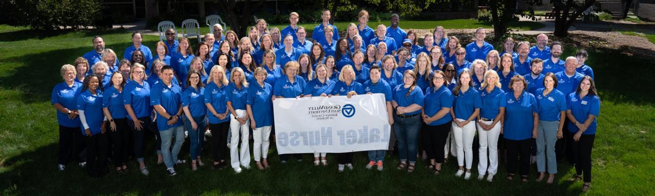 Group of people wearing blue polo shirts holding a laker nurse sign